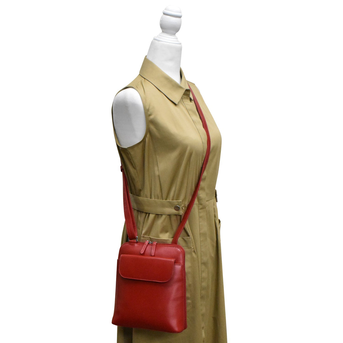 Mannequin wearing a beige trench coat with a red handbag on a white background