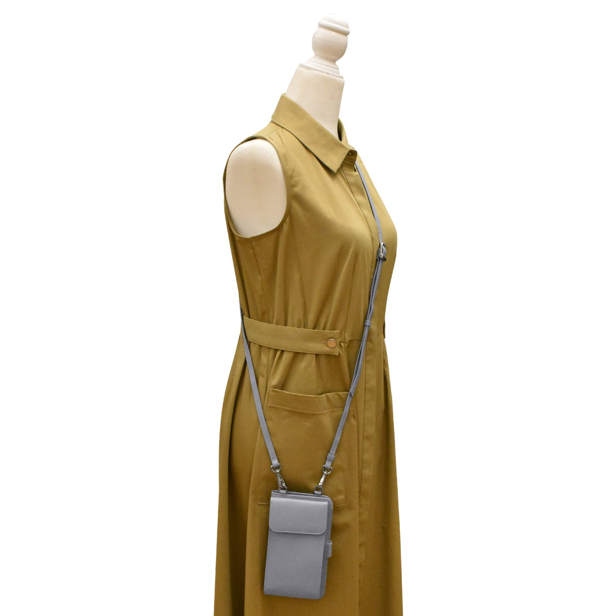 Mannequin wearing a mustard yellow dress with a matching crossbody bag on a white background