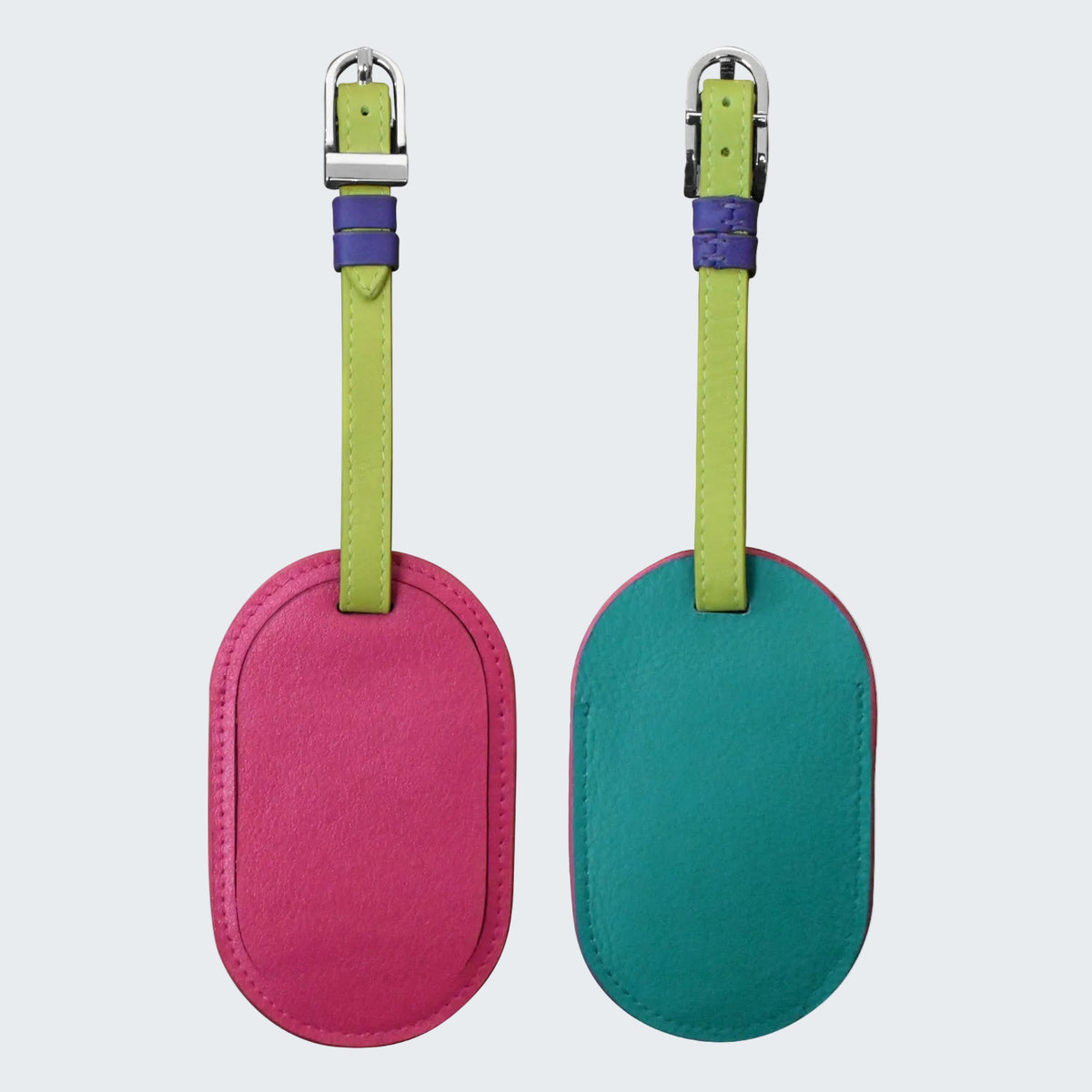 Two oval-shaped luggage tags, one pink and one green, with matching straps on a white background.