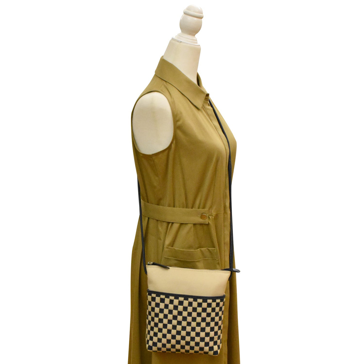 Green sleeveless dress with a matching handbag on a mannequin against a white background