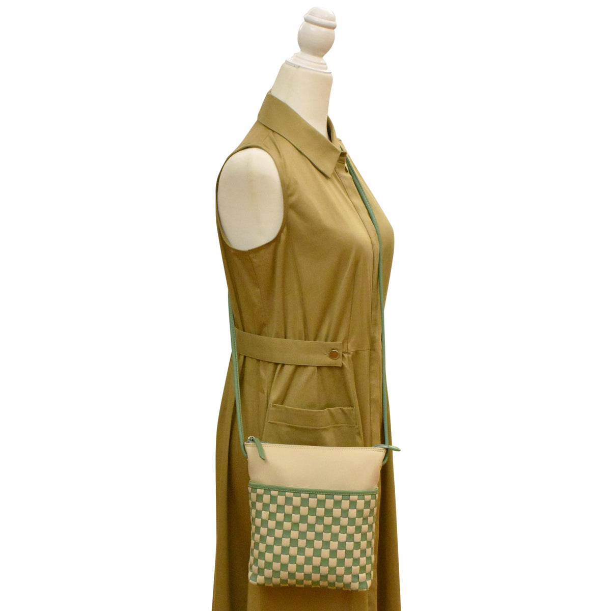 Green apron with a matching checkered pocket on a mannequin against a white background