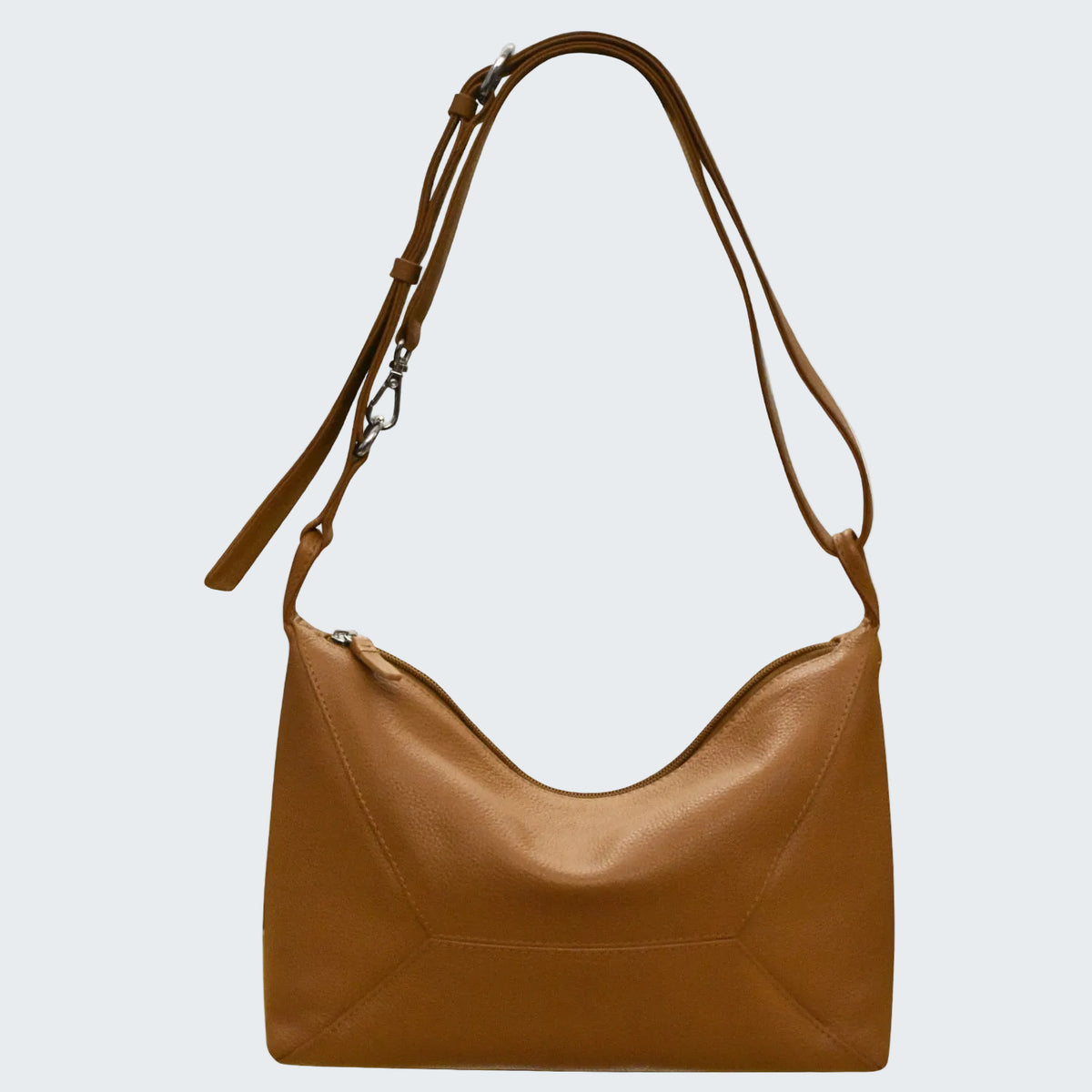 Brown leather handbag with a shoulder strap on a white background