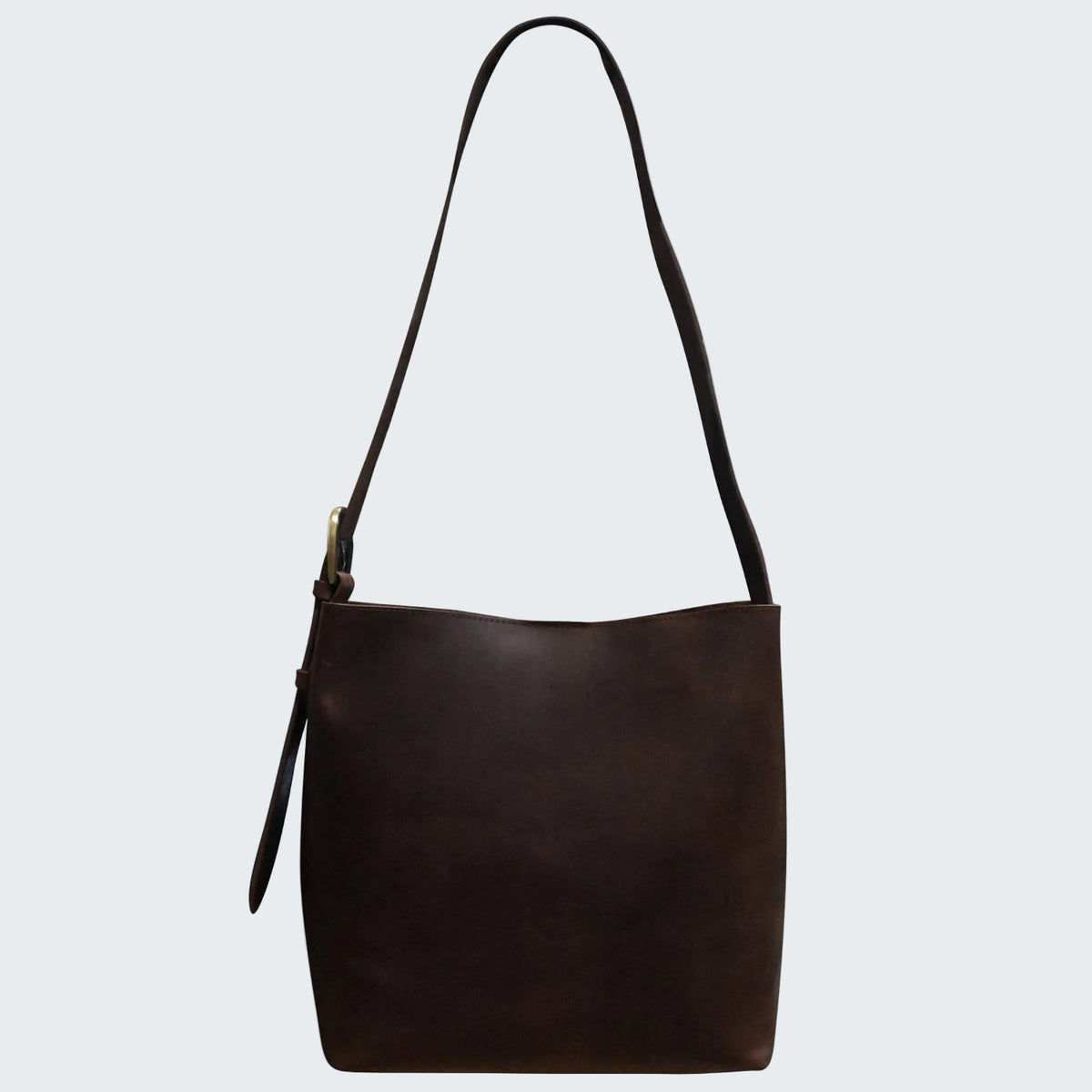 Brown leather handbag with a shoulder strap on a white background