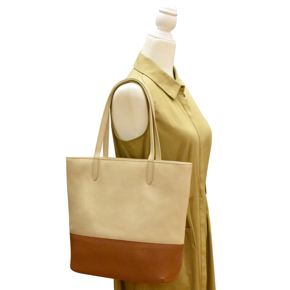 Beige and brown tote bag on a mannequin with a white background