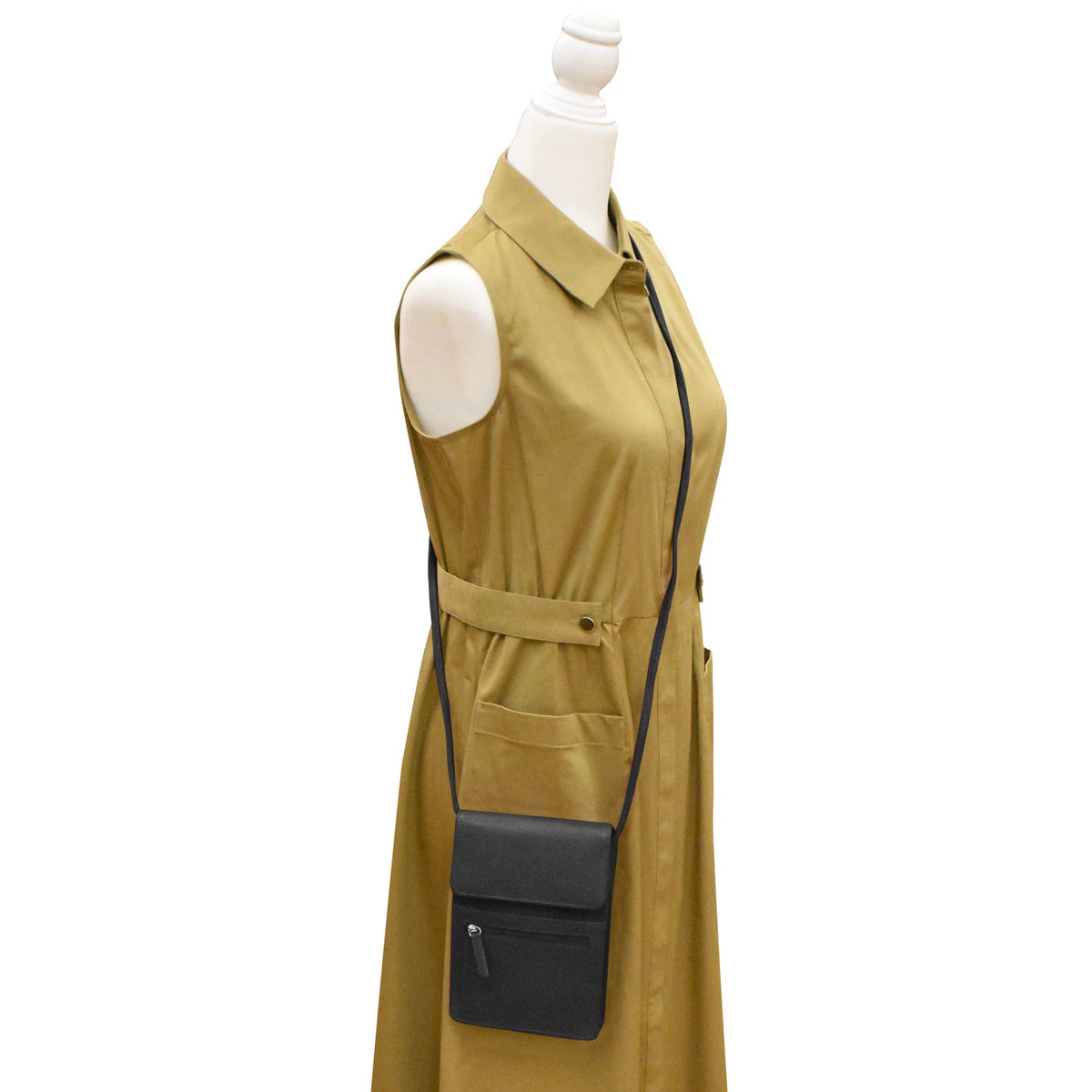 Mannequin wearing a mustard yellow dress with a black bag on a white background