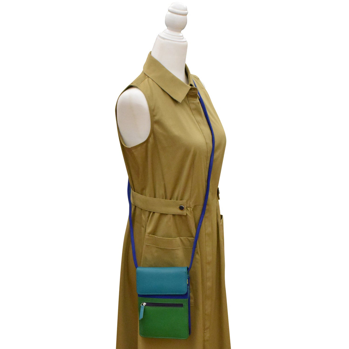 Mannequin wearing a beige trench coat with a green and blue bag on a white background