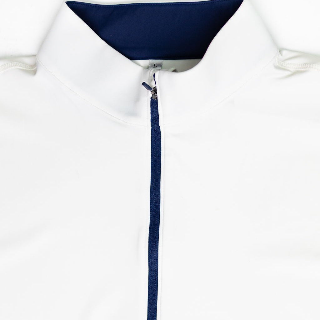 Close-up of a white collared athletic top with a navy blue inner collar and matching navy zipper placket.