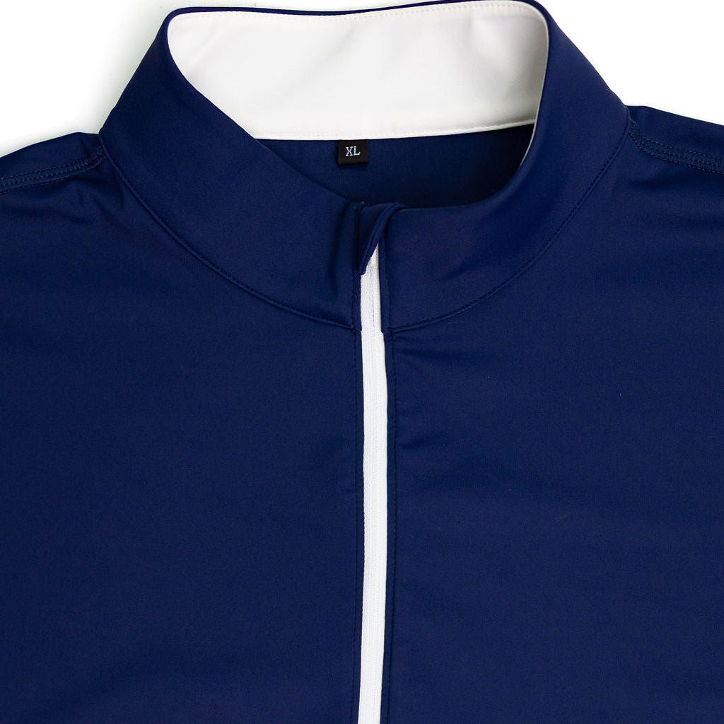 Close-up of a navy blue athletic quarter-zip pullover with a white inner collar lining and a white zipper placket.