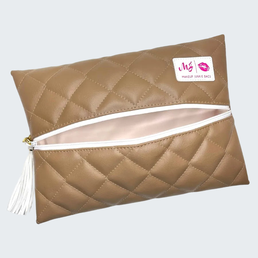 Quilted beige makeup bag with a white zipper on a white background
