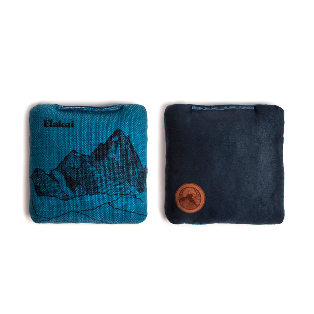 Two wristbands, one blue with a mountain design and the other black with a logo, on a white background.