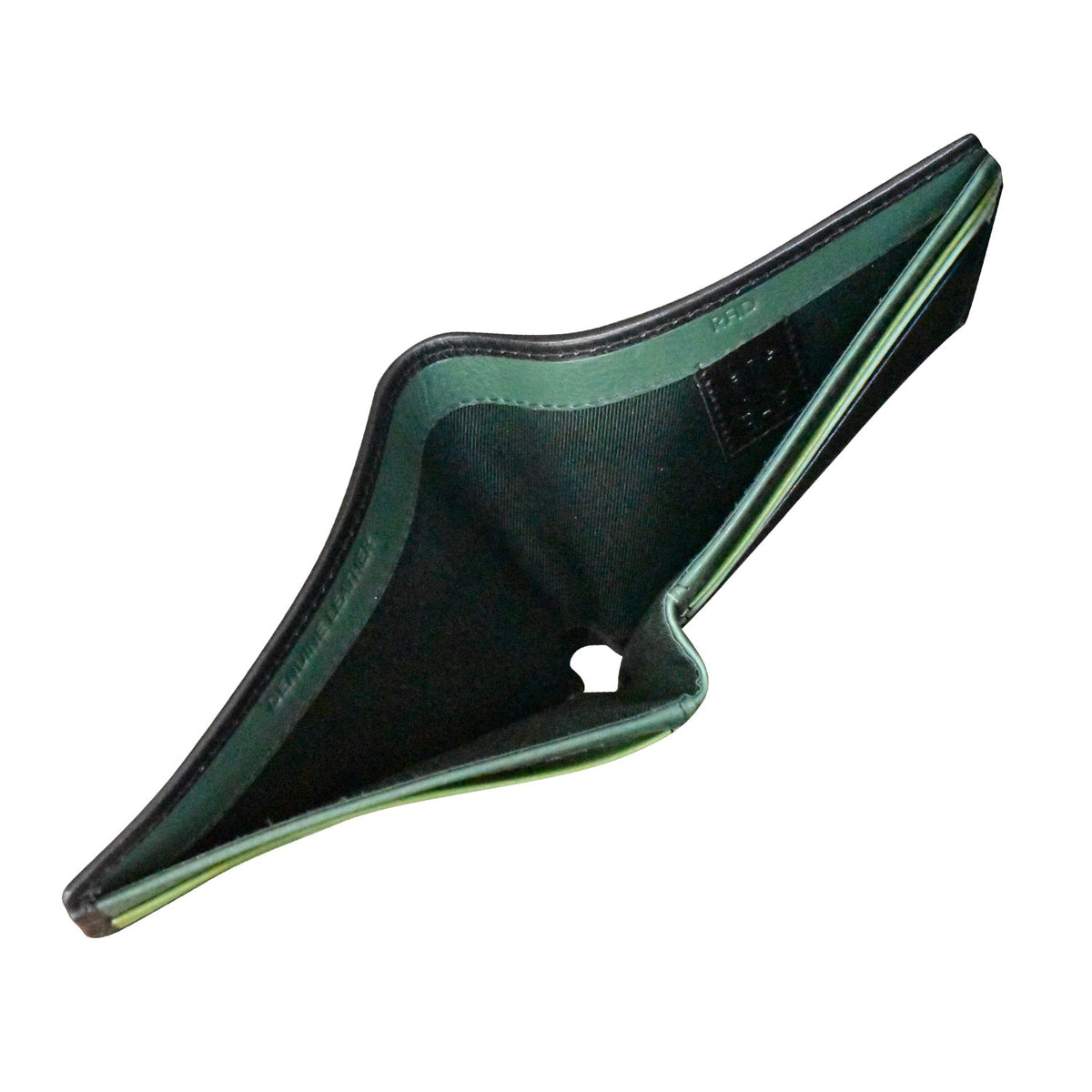 Black and green plastic component on a white background