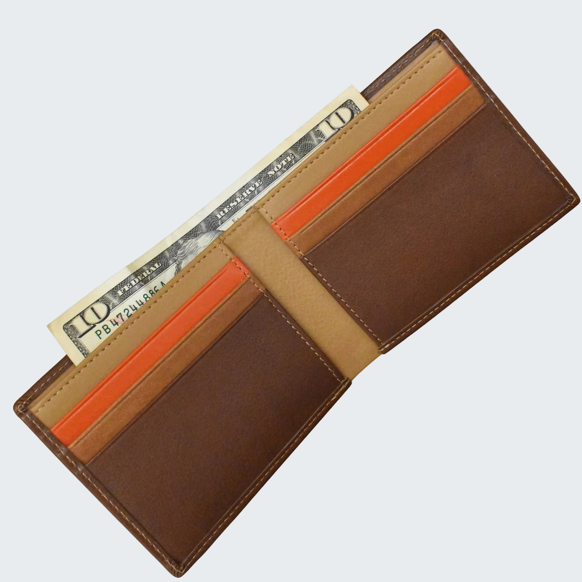 Brown wallet with orange interior pocket holding a dollar bill on a white background