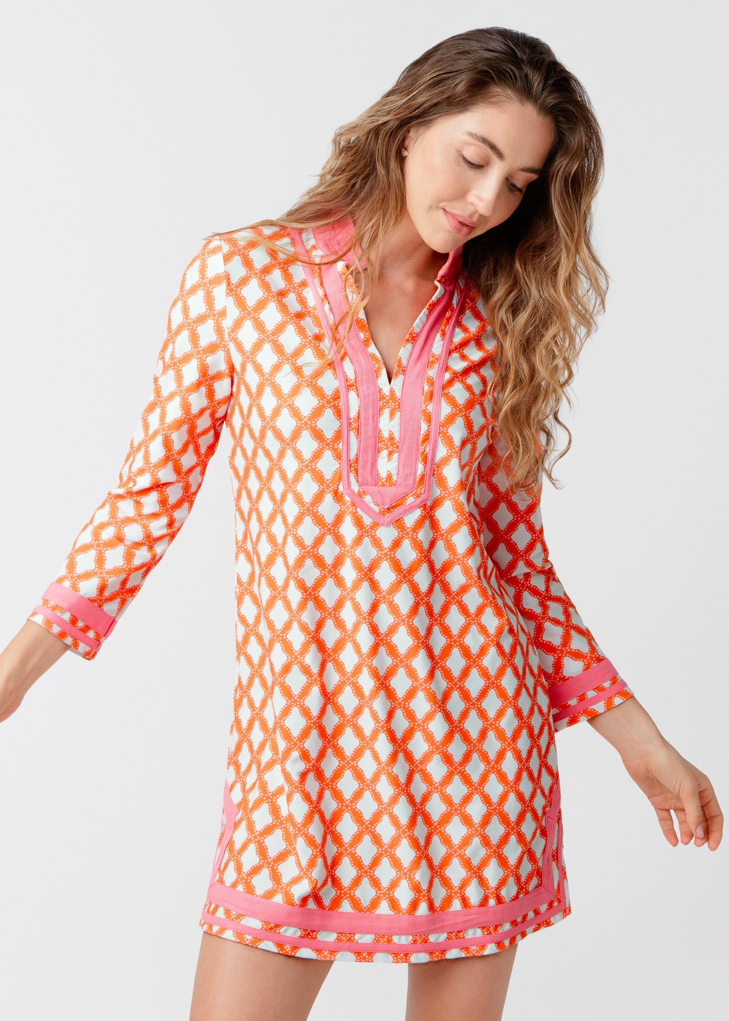 Woman wearing a colorful patterned dress on a white background