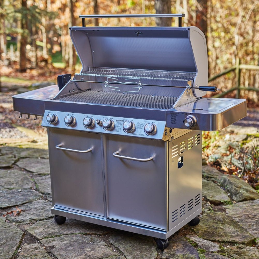 Stainless steel grill on a stone patio with a natural background