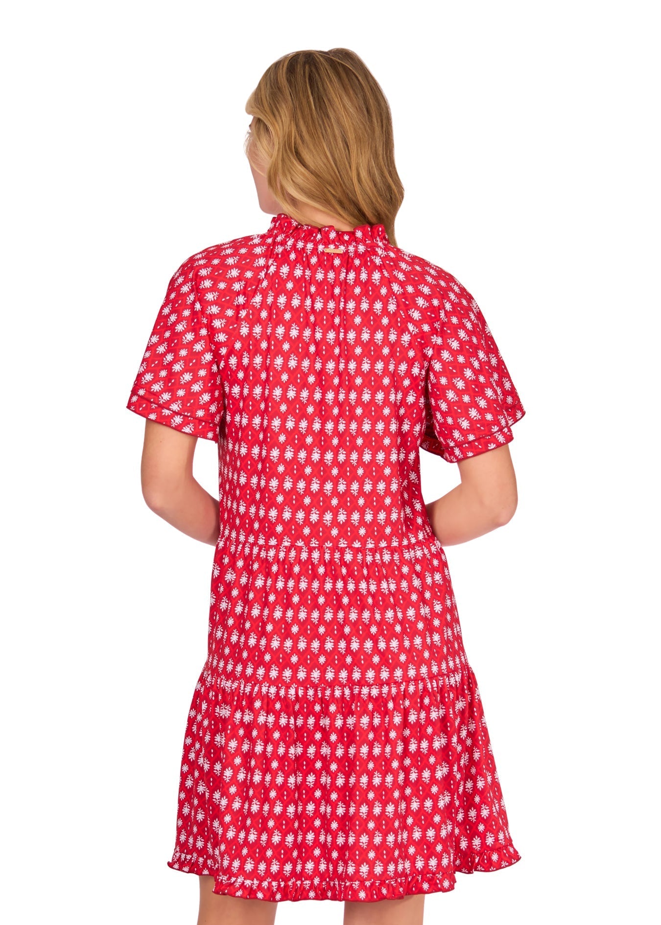 Woman wearing a red patterned dress on a white background