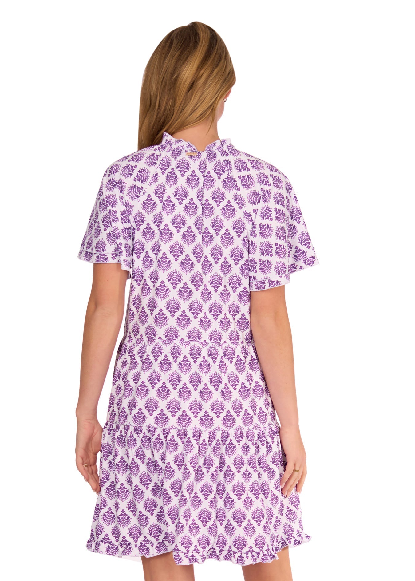 Woman wearing a purple and white patterned dress on a white background