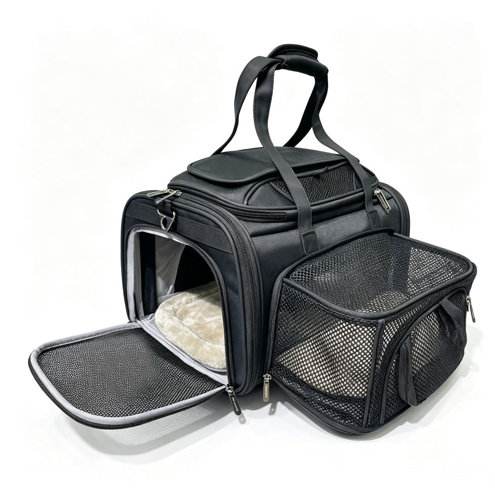 A black pet carrier bag with mesh windows and handles, shown open with a plush pet bed inside and an attached mesh side pouch, photographed on a clean white background.