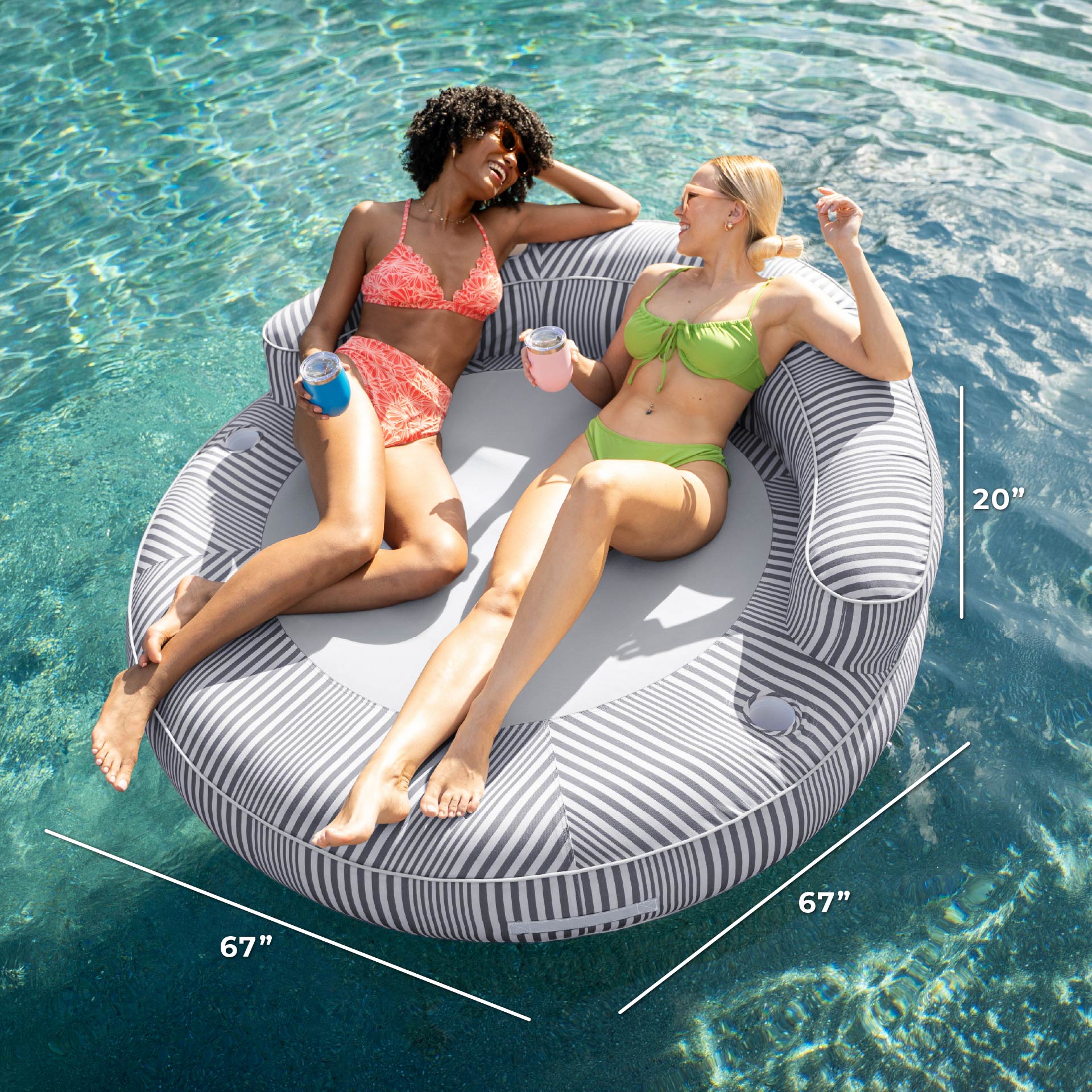 Two women relaxing on a circular pool float with measurements displayed.