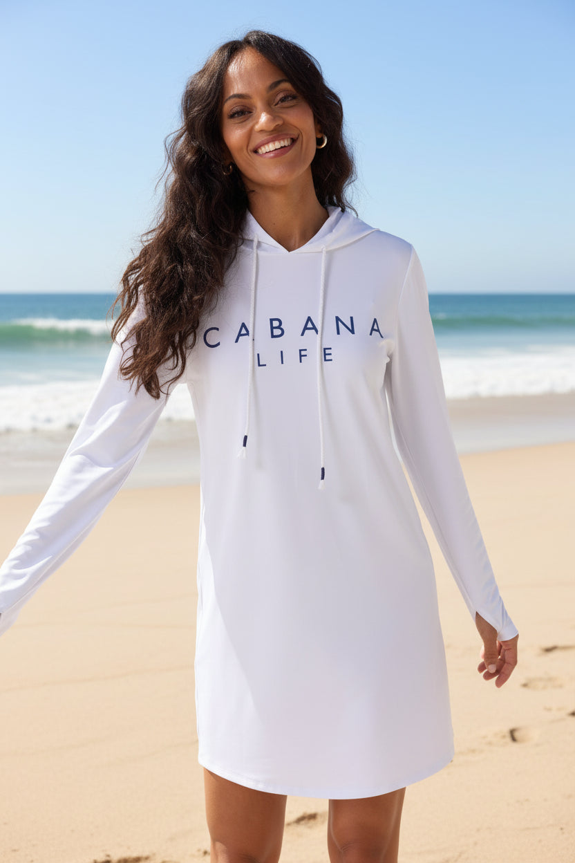 Woman wearing a white hoodie dress with 'Vacabana Life' text on a plain background