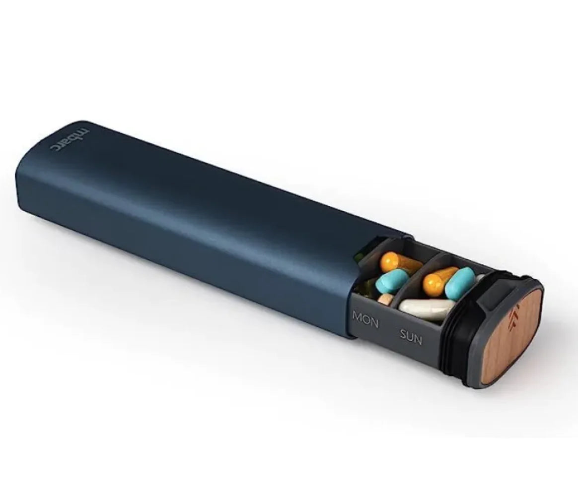 Blue pill organizer with compartments for different days of the week on a white background