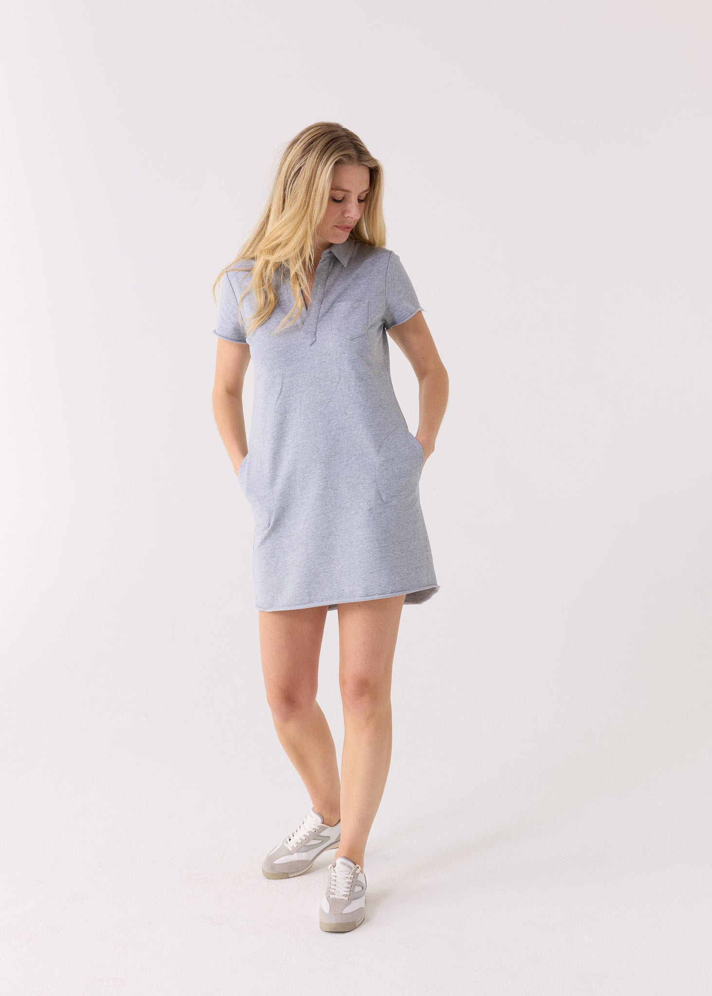 Woman wearing a light blue dress on a white background