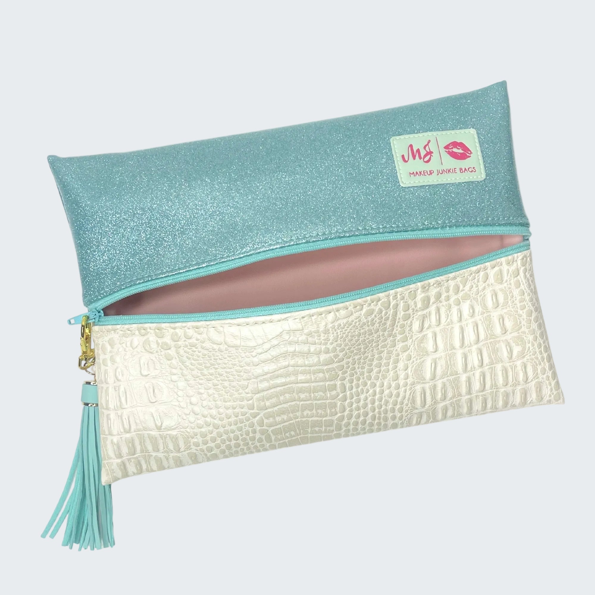 Makeup bag with turquoise top and white bottom, featuring a brand logo.