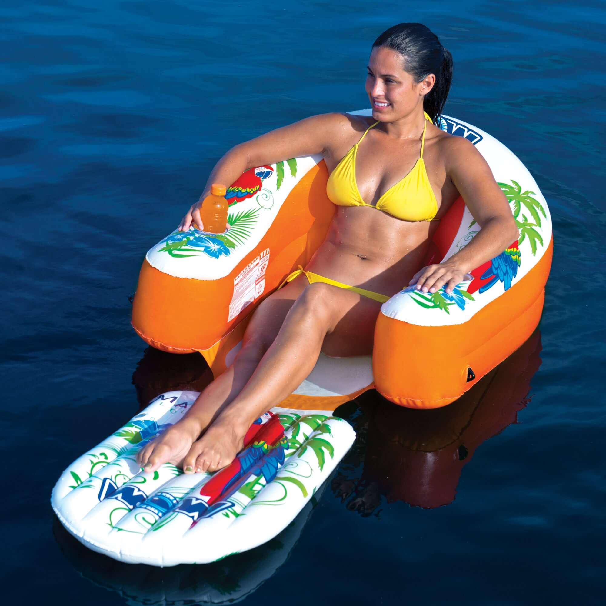Woman in a yellow bikini sitting on an inflatable tube in the water