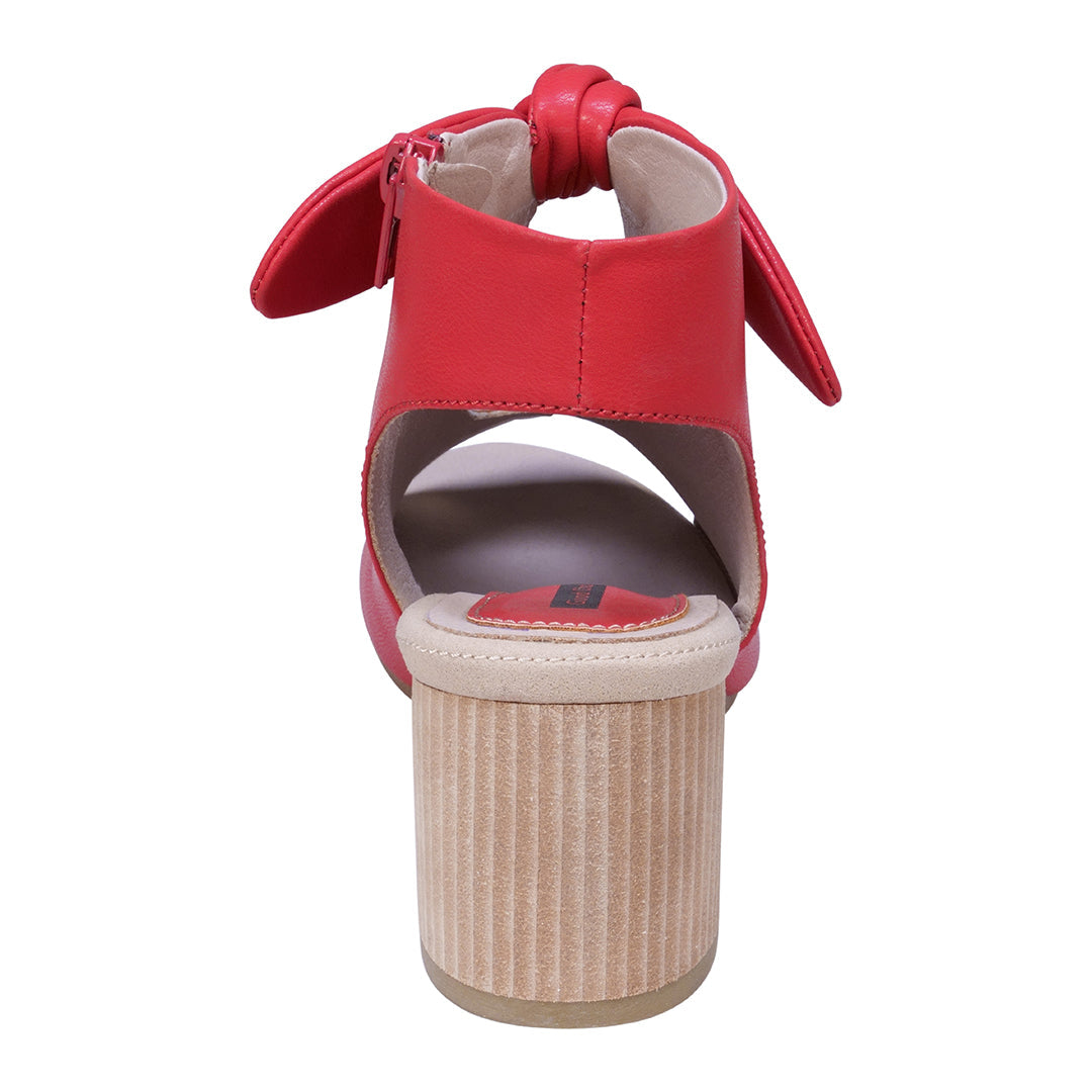 Red sandal with a woven heel on a white background