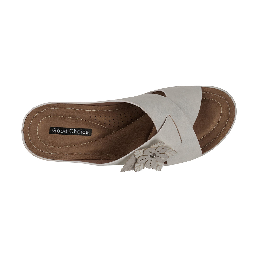 White sandal with brown sole on a white background