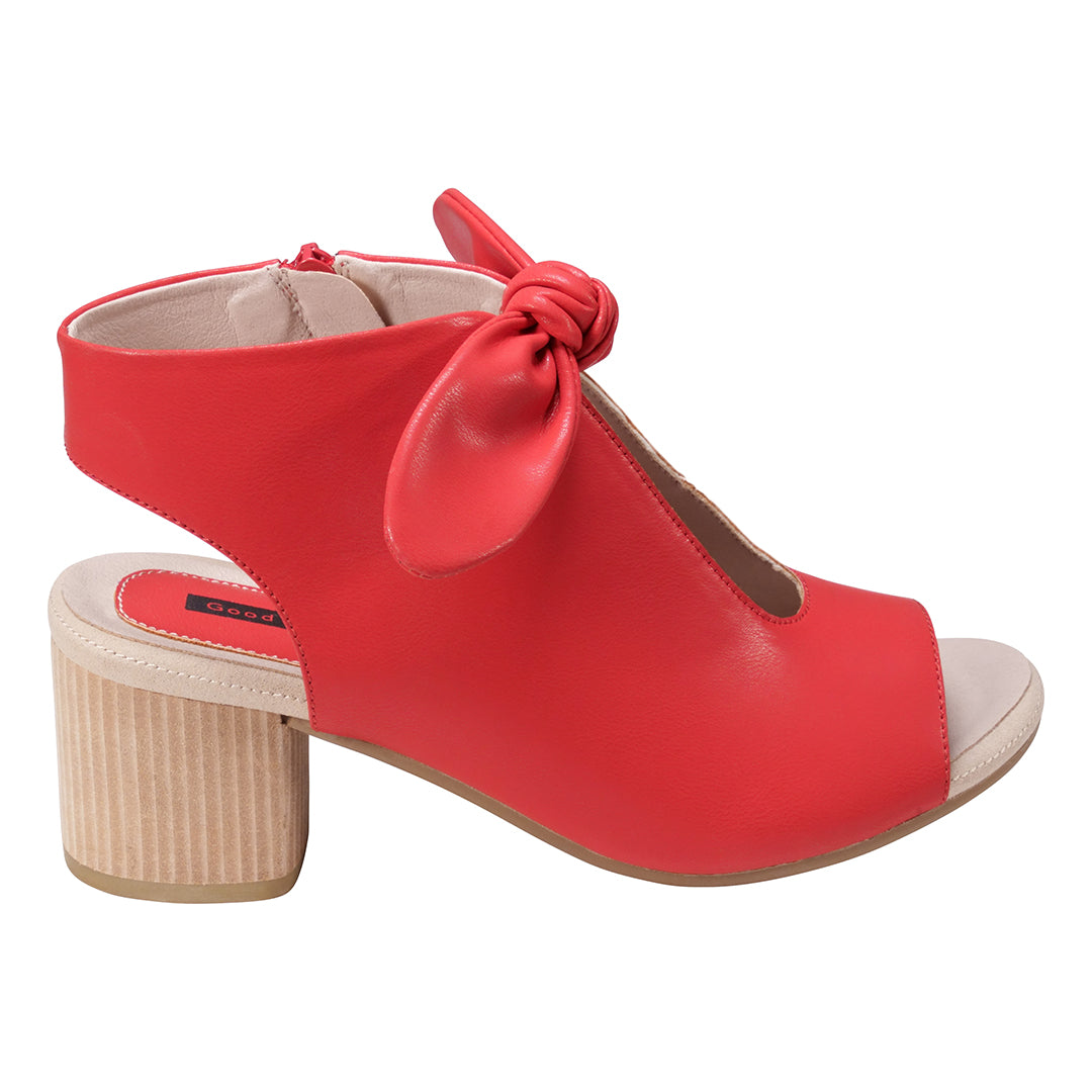 Red sandal with a bow on a white background