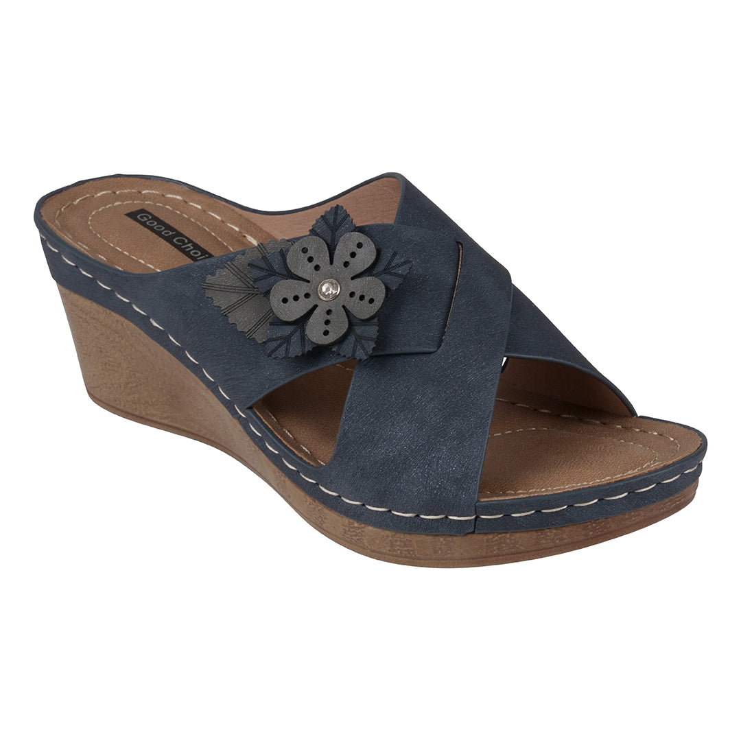 Navy wedge sandal with a flower detail on a white background