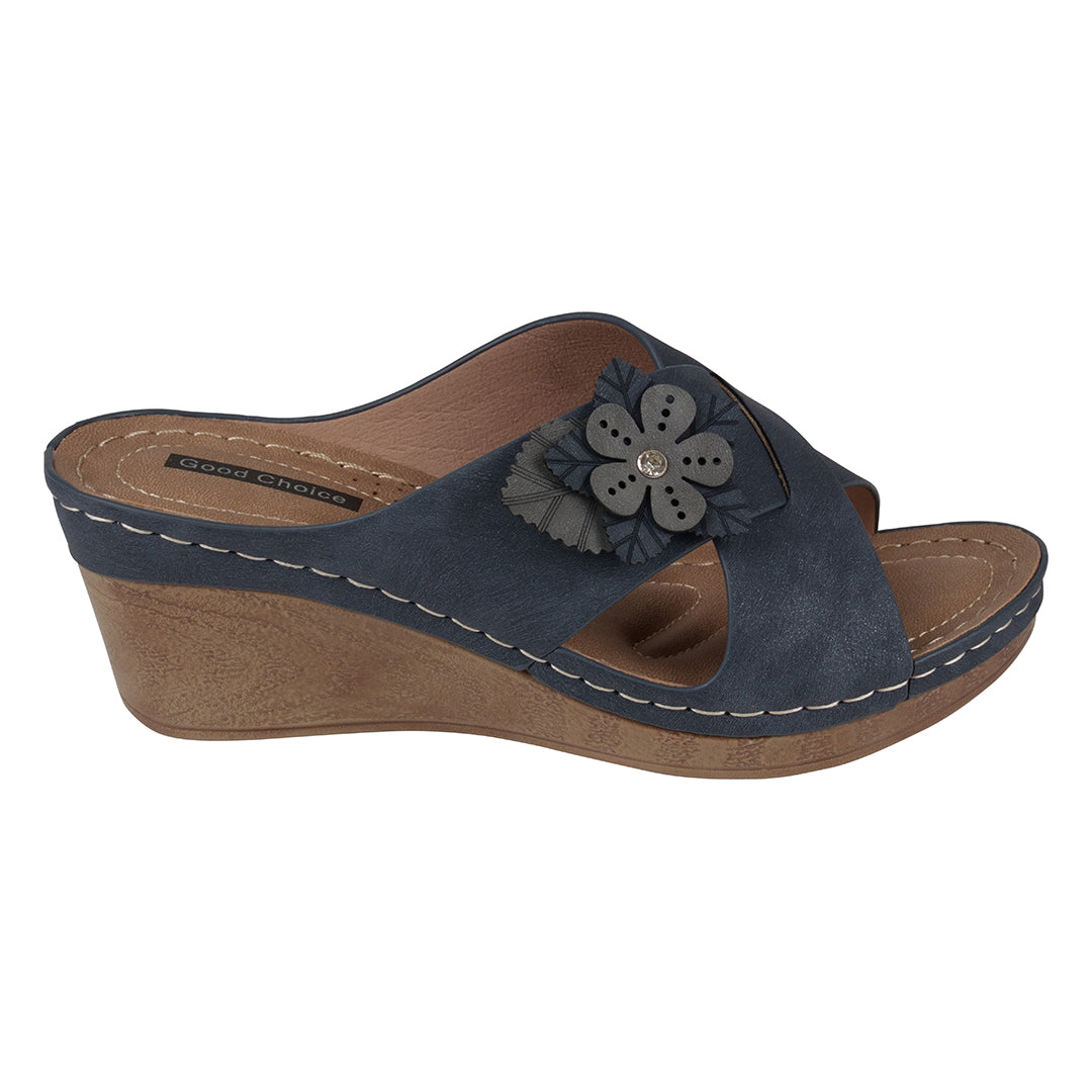 Navy wedge sandal with a flower detail on a white background