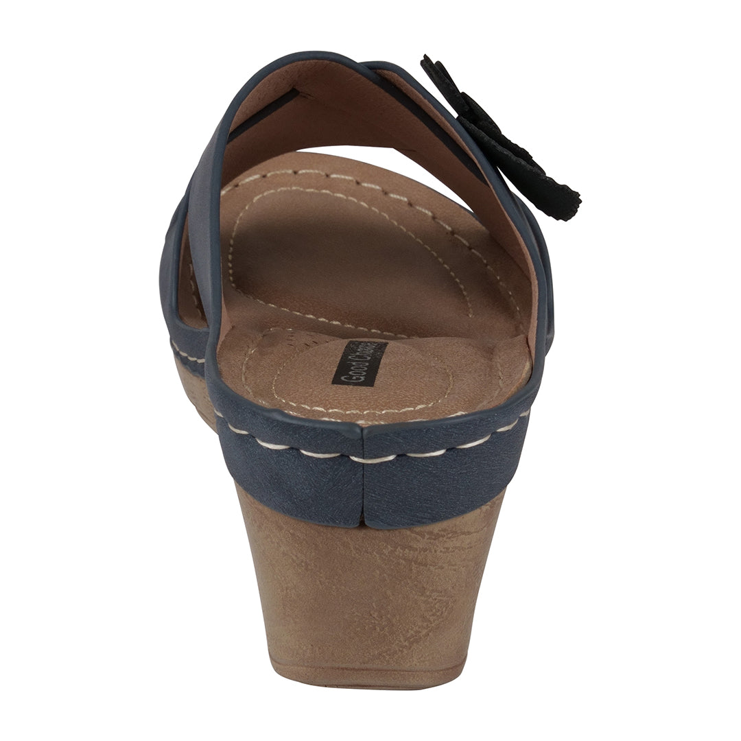 Brown sandal with blue straps on a white background