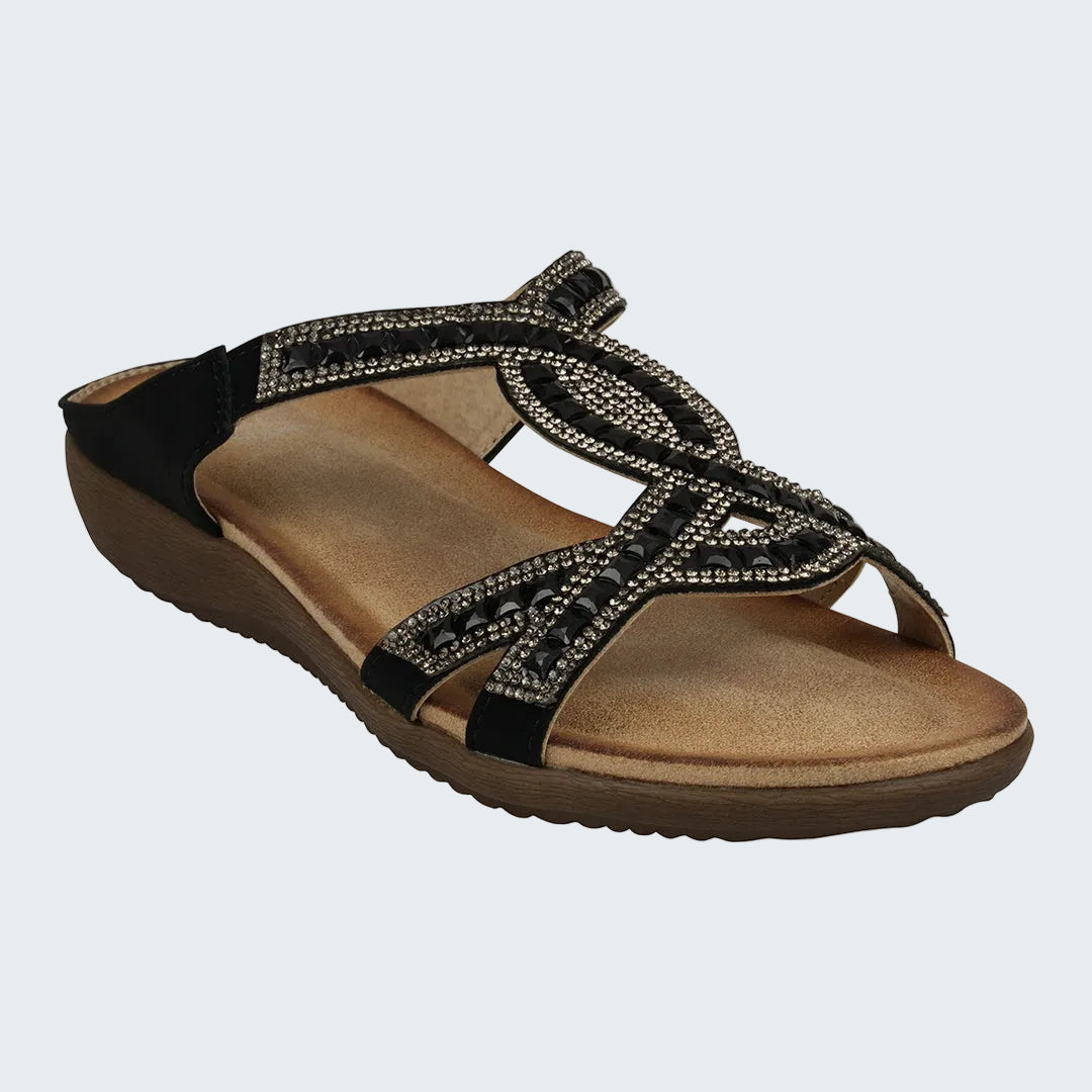 Brown sandal with black straps and embellishments on a white background