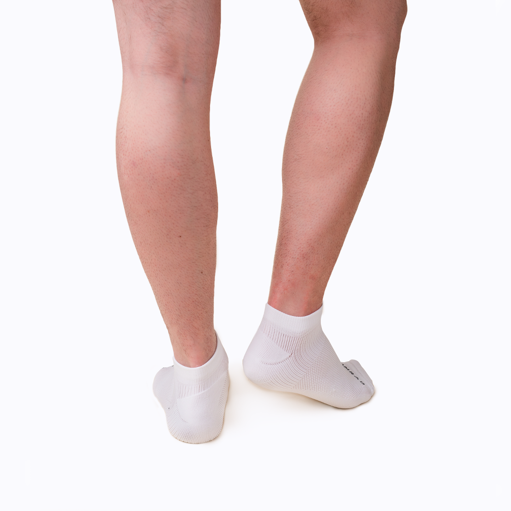 White socks worn on feet against a white background
