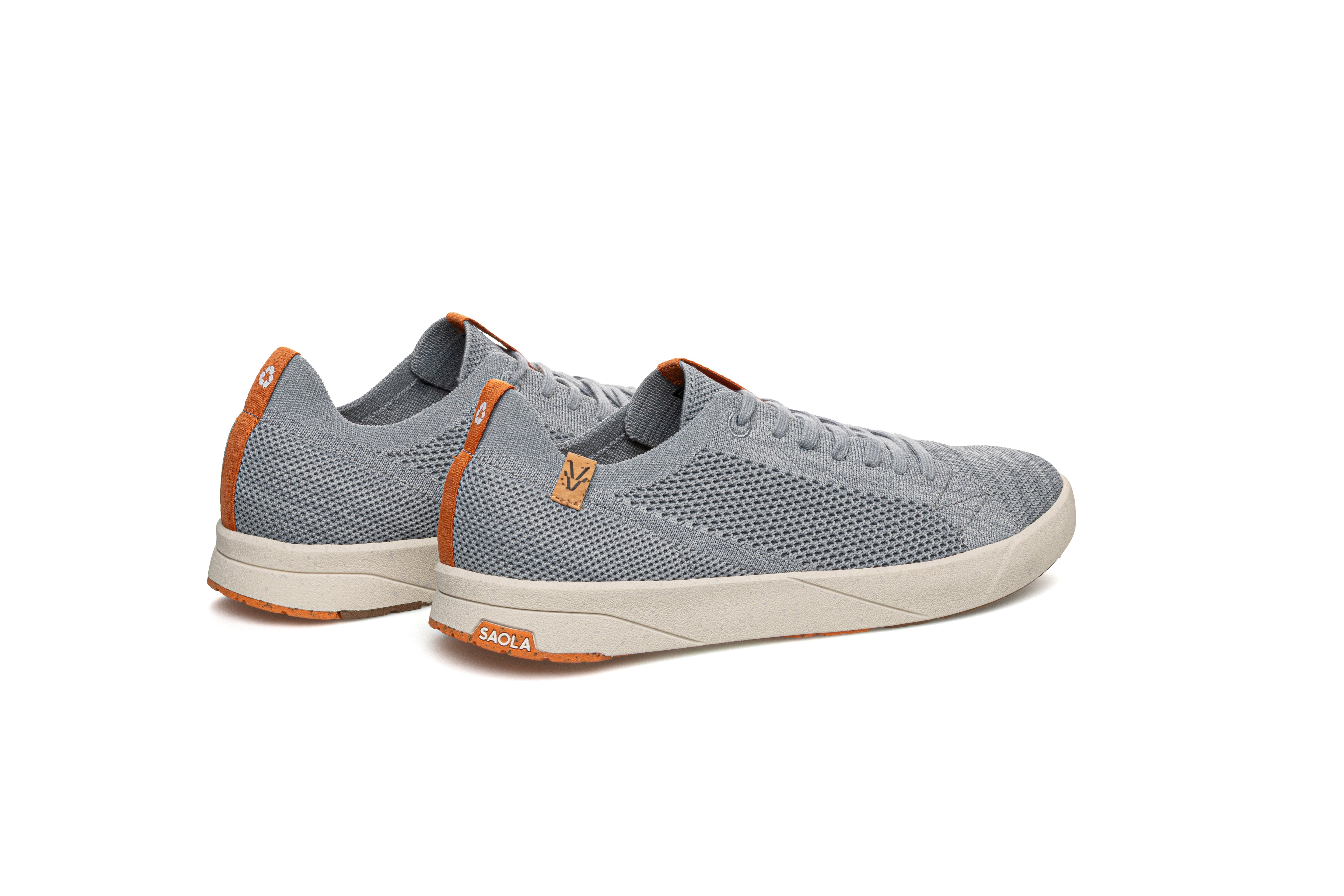 Gray sneakers with orange accents on a white background