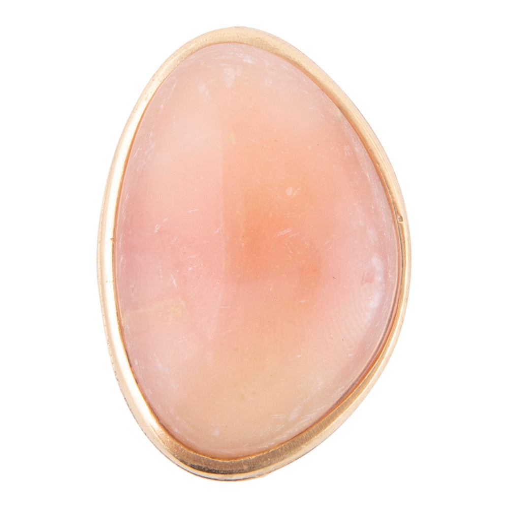 A single teardrop-shaped peach pink stone, likely a rose quartz cabochon, set in a gold bezel setting against a plain white background.