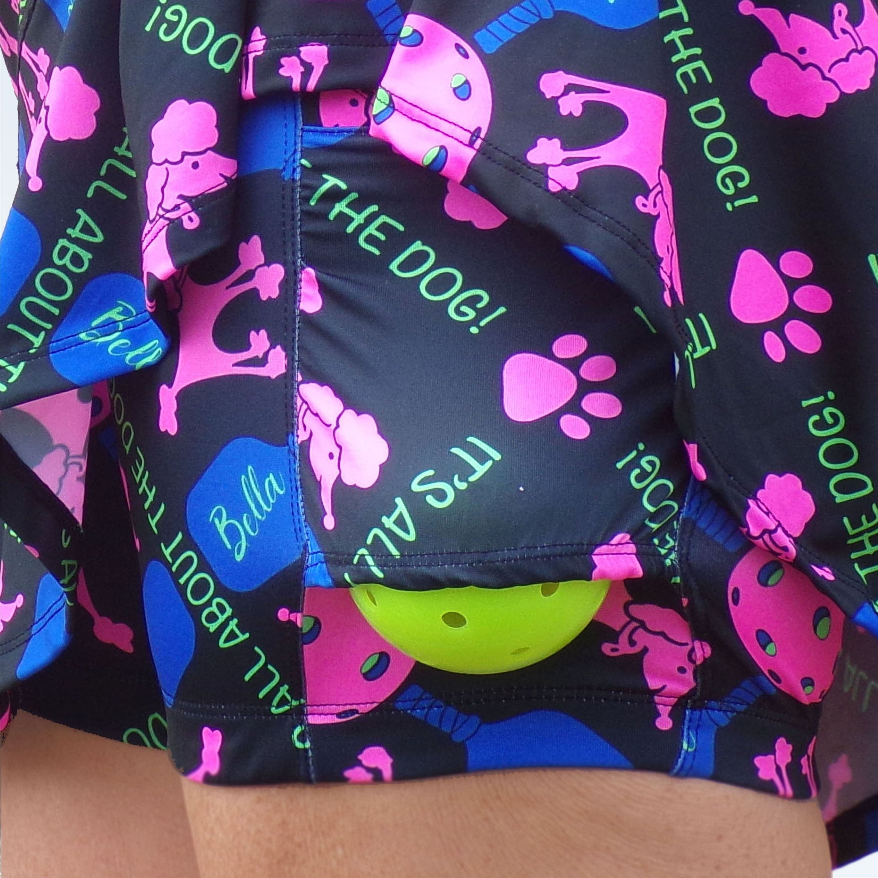 Close-up of colorful shorts with dog-themed design and text.