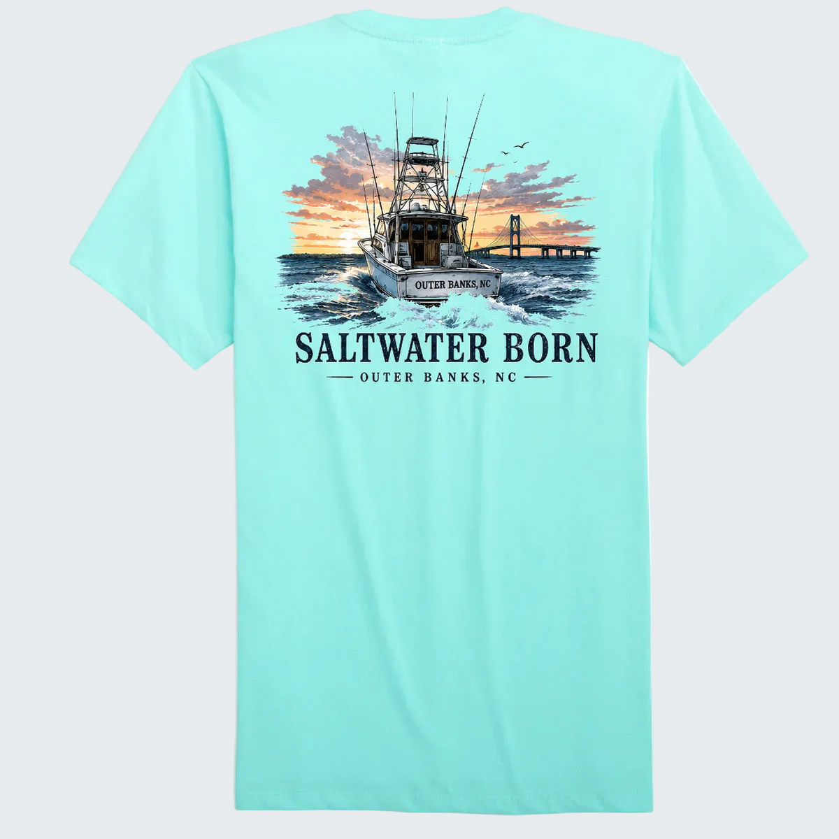 A light aqua blue short-sleeve t-shirt shown from the back, featuring a large graphic print of a fishing boat on the water at sunset with the text 'SALTWATER BORN' and 'OUTER BANKS, NC'.