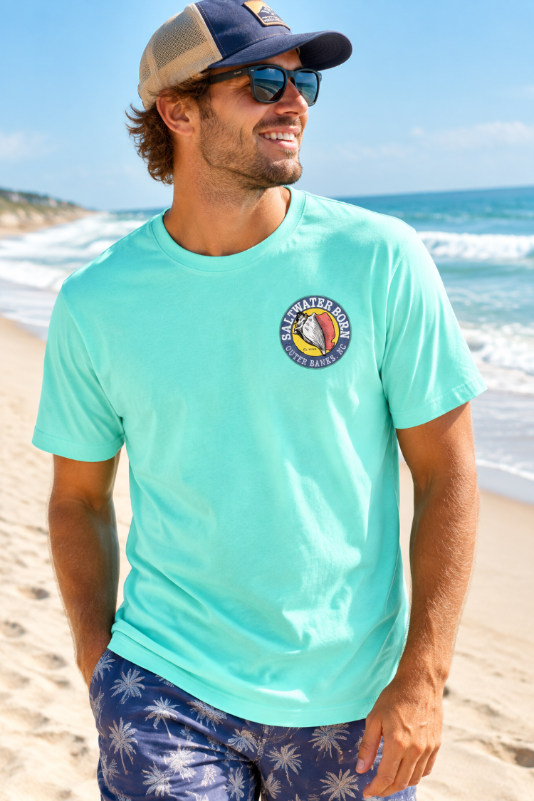 A light aqua short-sleeve crewneck t-shirt with a circular 'Salt Water Vibes - Ocean Breeze' graphic printed on the left chest, displayed on a clean white background.