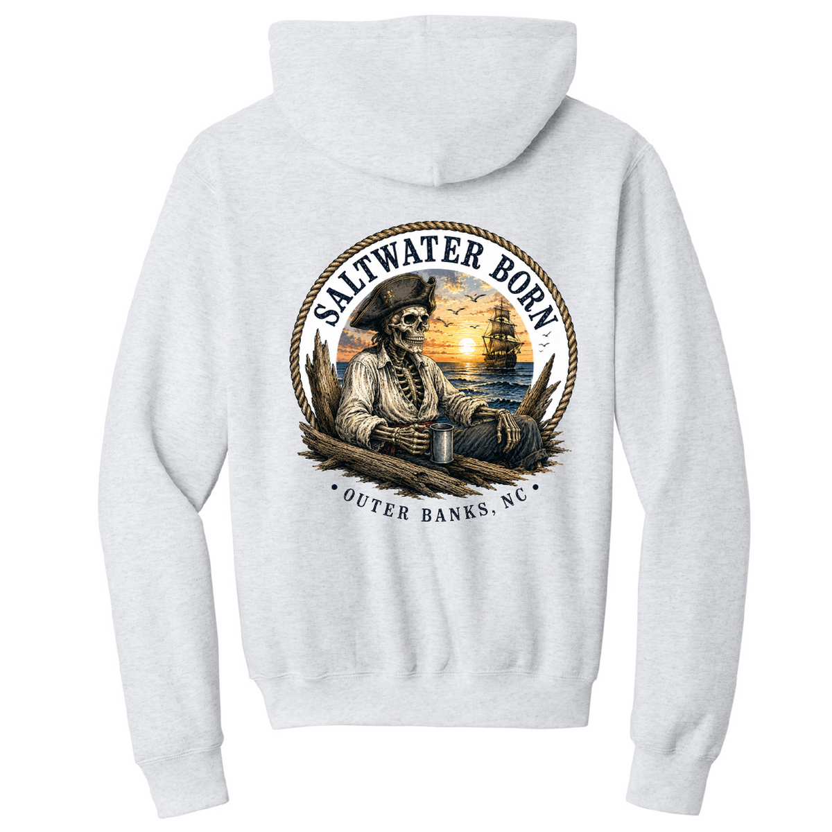 A light heather gray pullover hoodie shown from the back, featuring a large circular graphic print with a skeleton sailor, sunset, ship, and the text 'SALTWATER BORN' and 'OUTER BANKS, NC'.