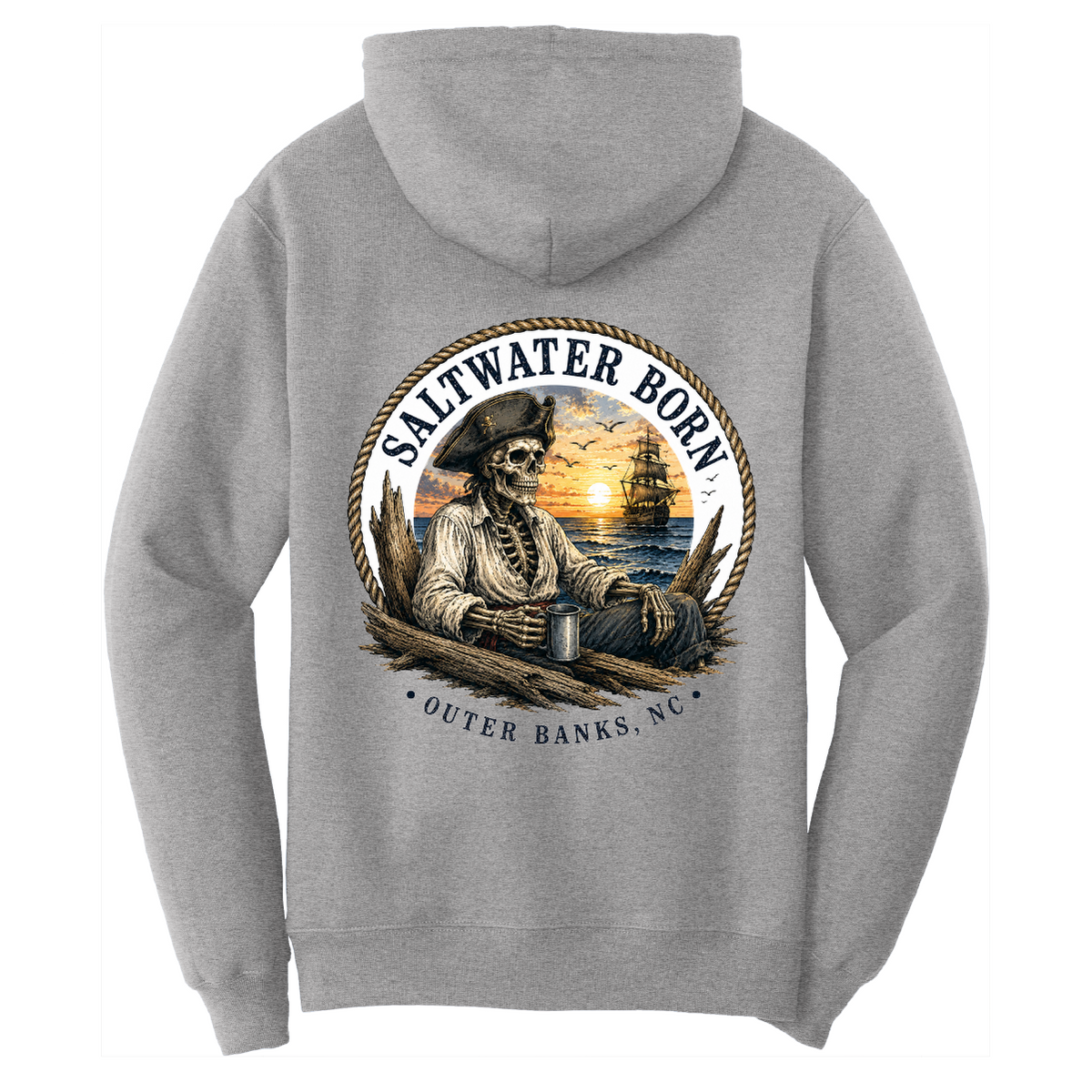 A light gray hooded sweatshirt shown from the back, featuring a large circular graphic print of a skeleton pirate holding a mug with a sunset and ship in the background. The text reads 'SALTWATER BORN' and 'OUTER BANKS, NC'.