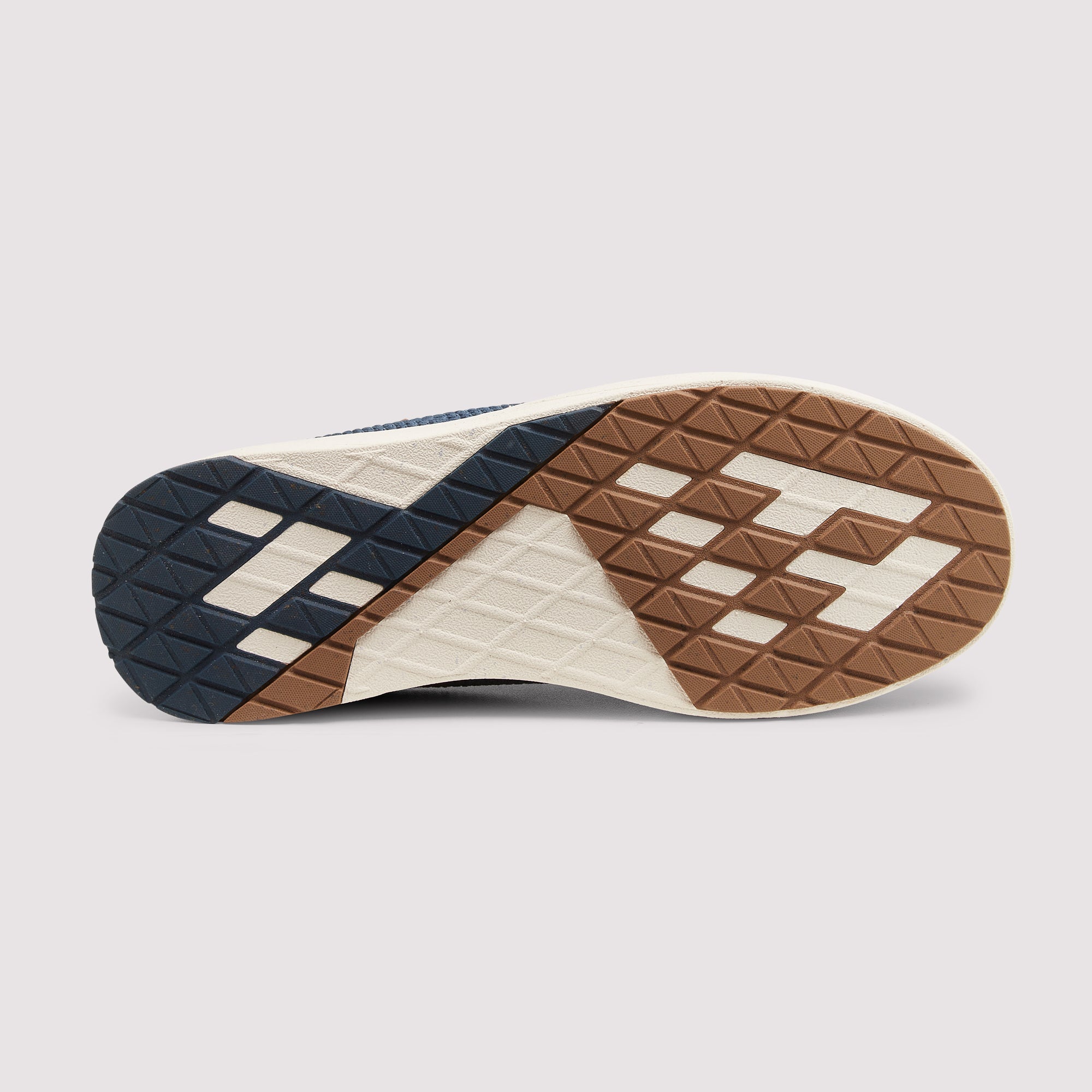 Close-up of a shoe sole with a textured pattern on a light gray background