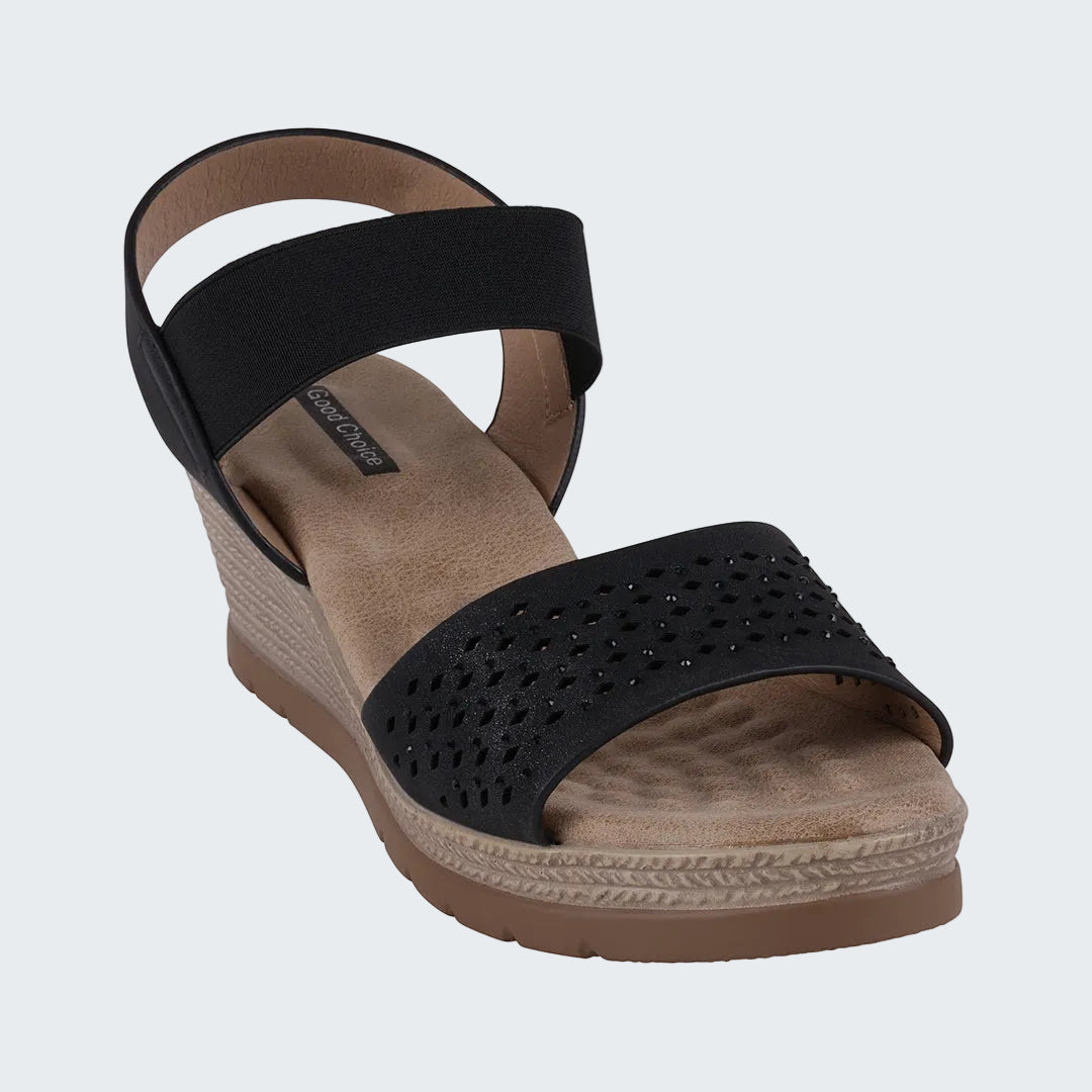 Black wedge sandal with a brown sole on a white background