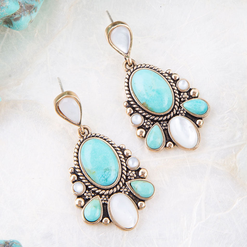 Turquoise and white stone earrings on a light background
