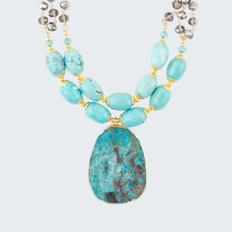 Necklace with turquoise beads and a large central stone on a white background