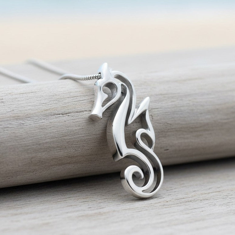 Silver seahorse pendant on a wooden surface