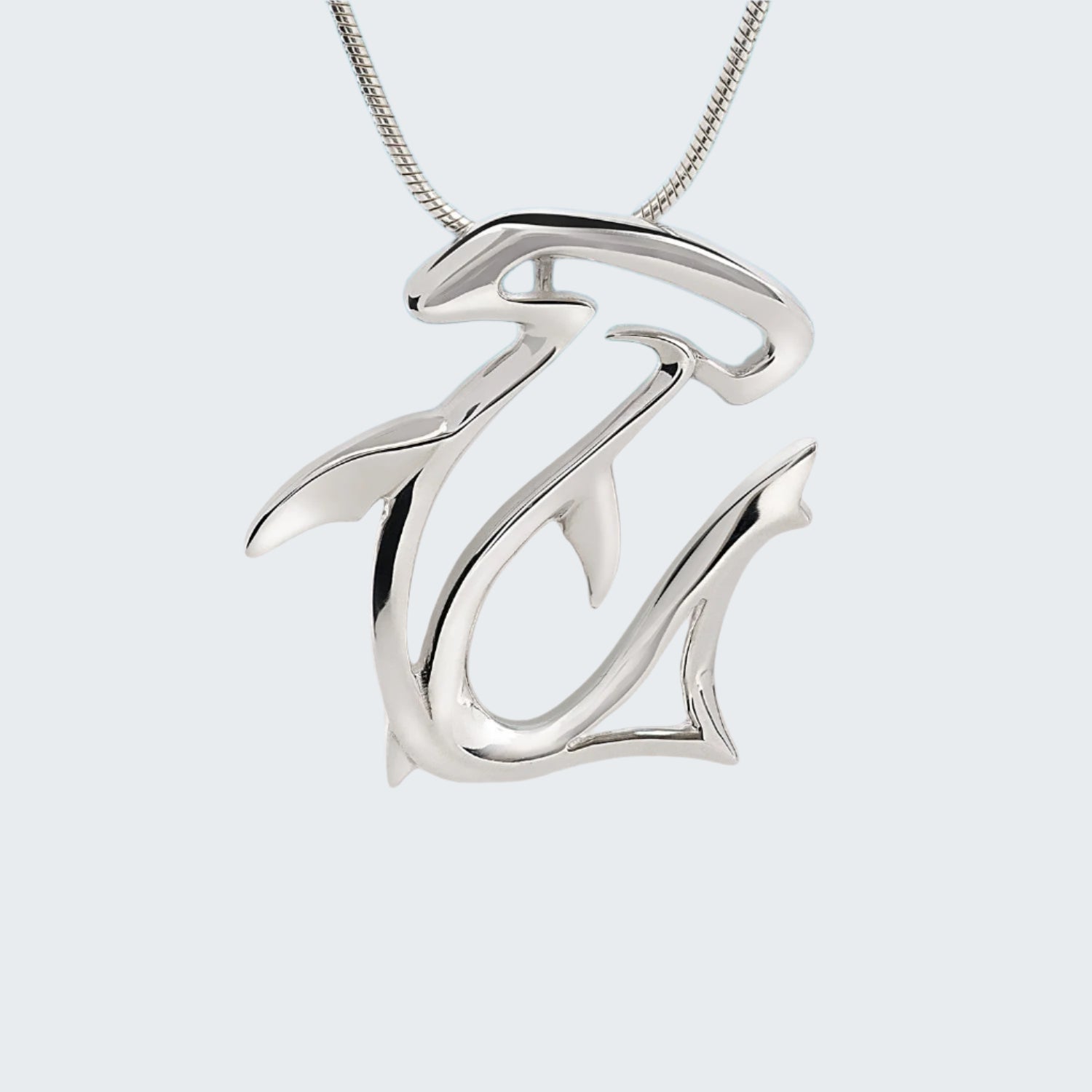 Silver necklace with a unique pendant on a light gray background