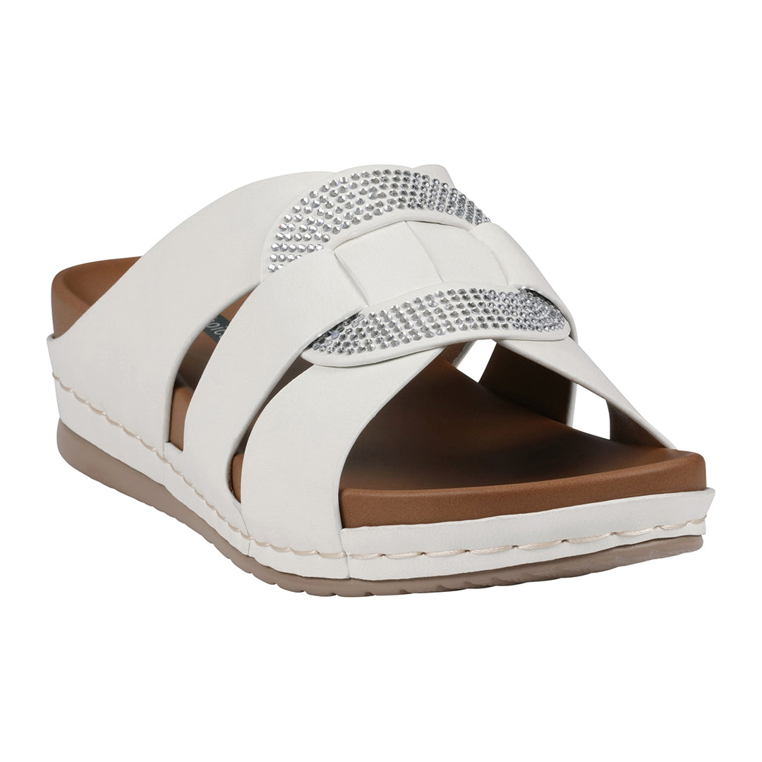 White sandal with brown sole and rhinestone embellishments on a white background