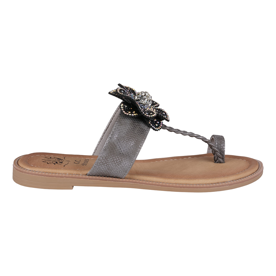 Silver sandal with decorative strap on a white background